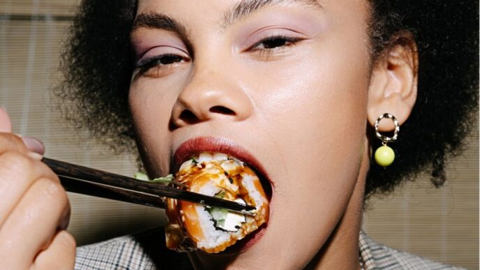 afvallen na een ongezond weekend foto van vrouw die sushi eet